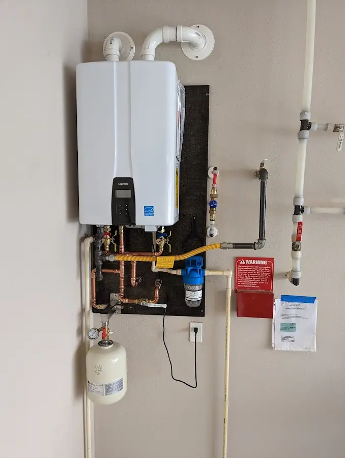 Professional plumber installing copper piping in a Camdenton home